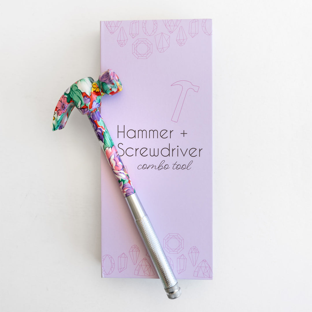 Floral-patterned hammer and screwdriver combo tool on a purple box with text