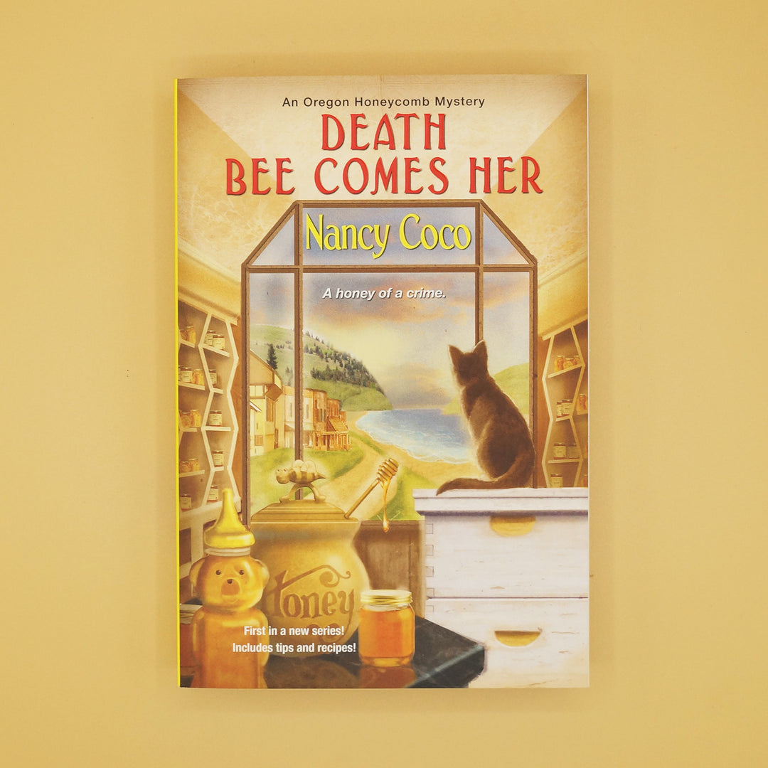 a paperback edition of Death Bee Comes Her by Nancy Coco
