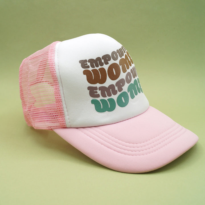 a pink snapback trucker hat that says "empowered women empower women" on the front