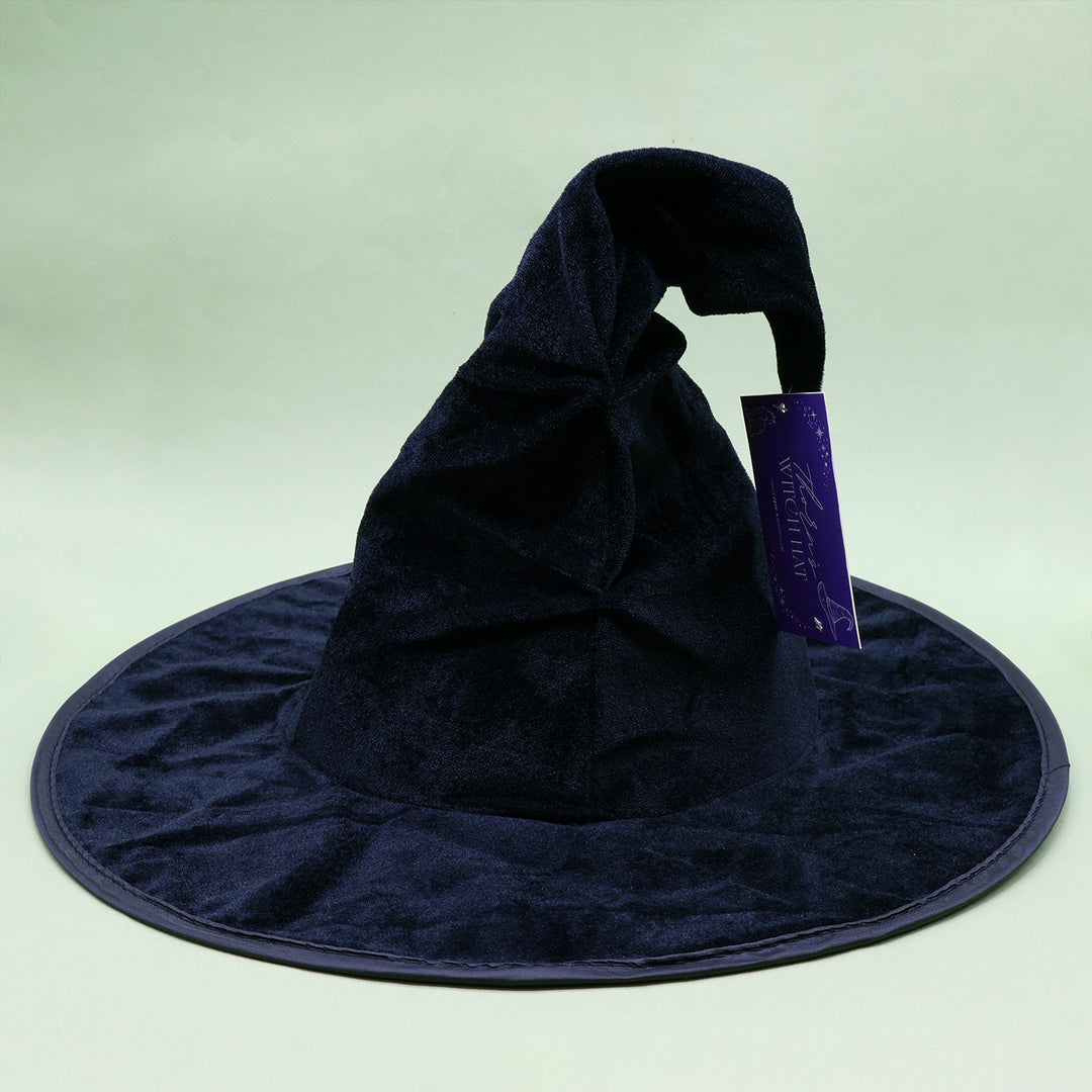 A black felt witch hat sits against a light green background.