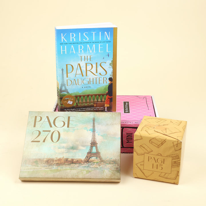 A book and its packaging displayed on a warm cream background: the front cover of Kristin Harmel's 'The Paris Daughter' book stands upright, with a pink book box behind it and two smaller tan paper gift boxes in front labeled 'PAGE 270' and 'PAGE 145'.