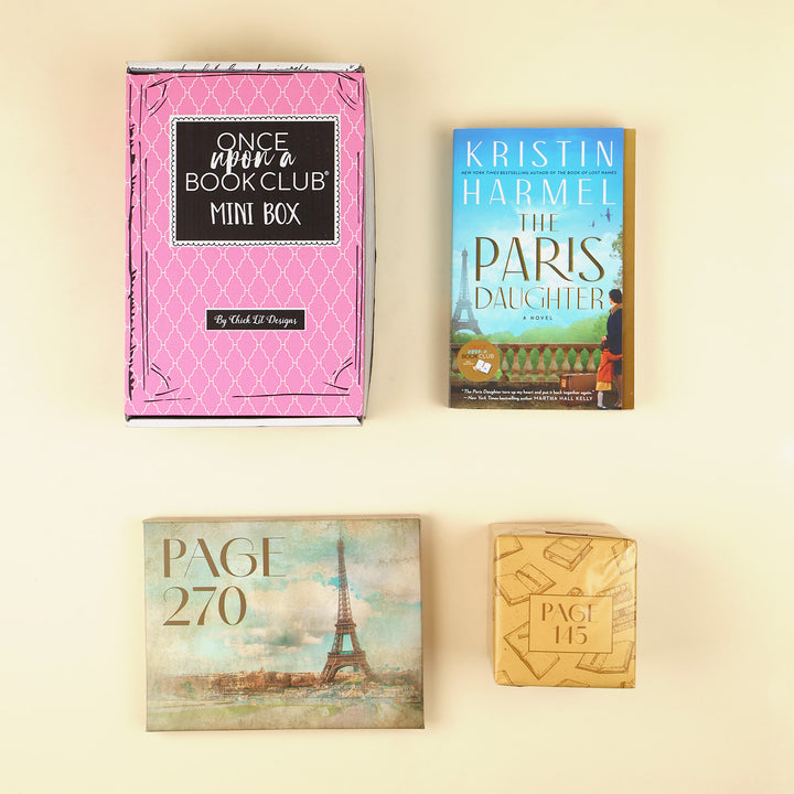 Four items arranged on a light cream background: a pink 'Once Upon a Bookclub Mini Box' box, the book cover of Kristin Harmel's 'The Paris Daughter', a rectangular gift labeled with 'PAGE 270' wrapped with an Eiffel Tower design, and a small tan box labeled with 'PAGE 15' wrapped in a book pattern design.