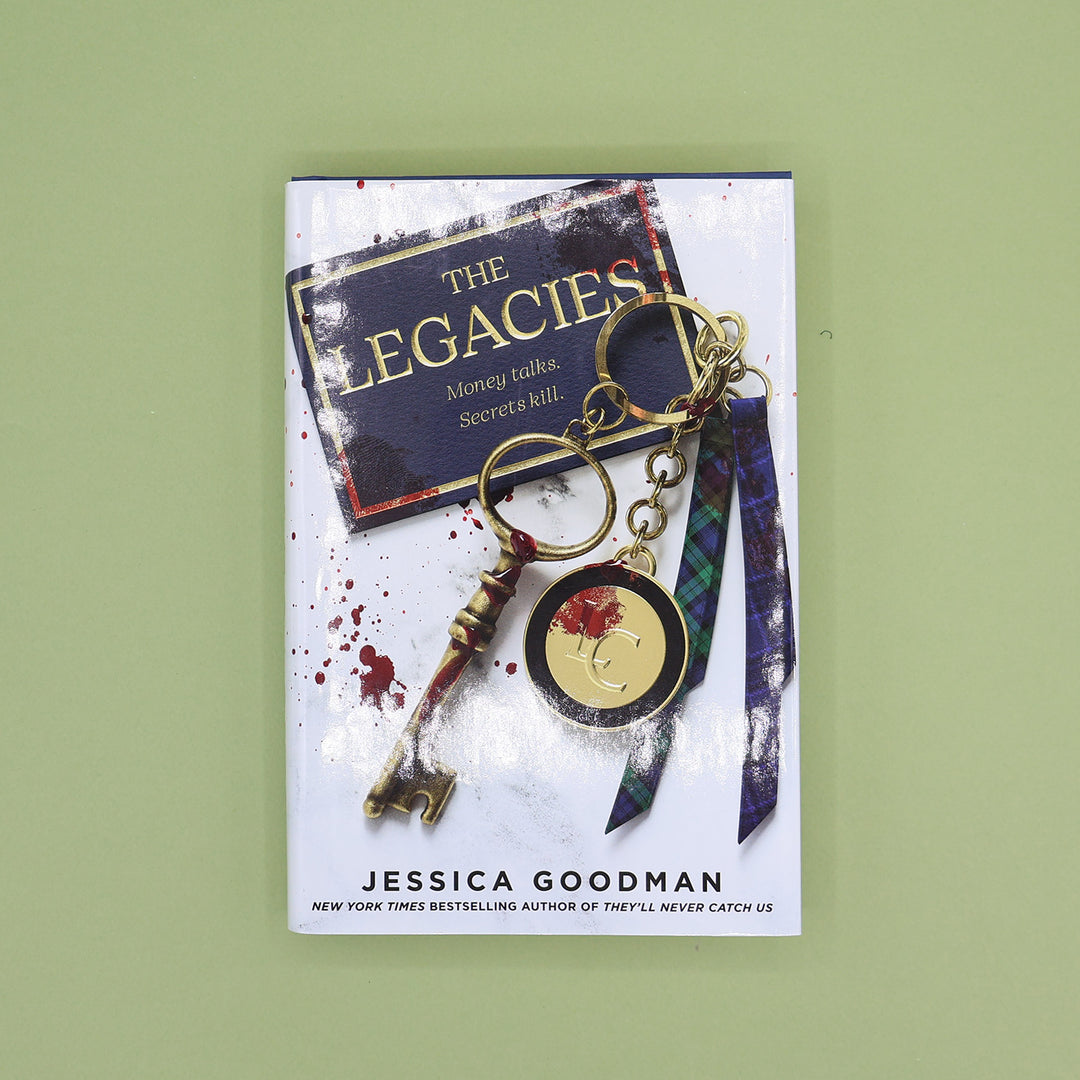 Book titled 'The Legacies' by Jessica Goodman with a keychain on a green background
