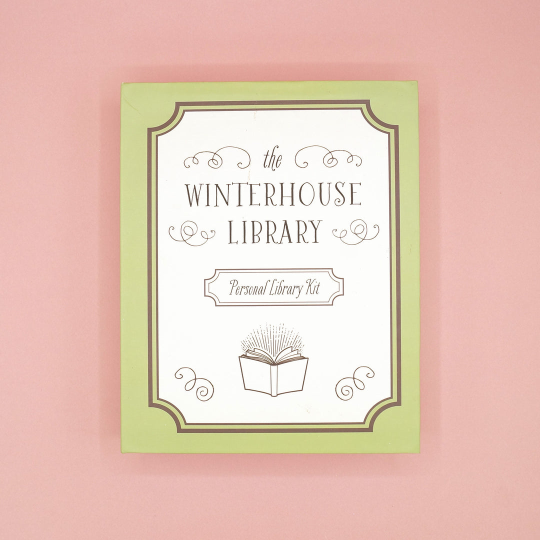The Winterhouse Library Personal Library Kit custom box on a pink background