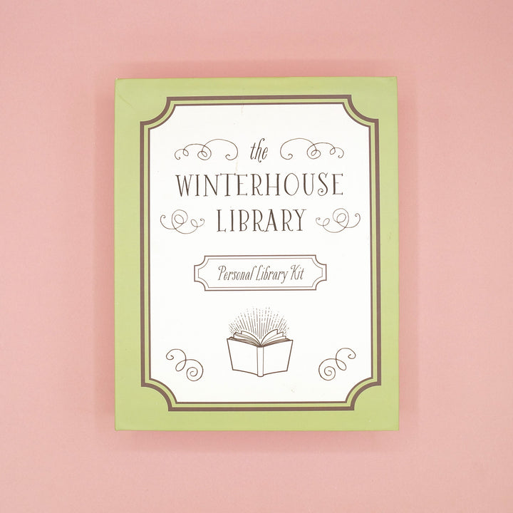 The Winterhouse Library Personal Library Kit custom box on a pink background