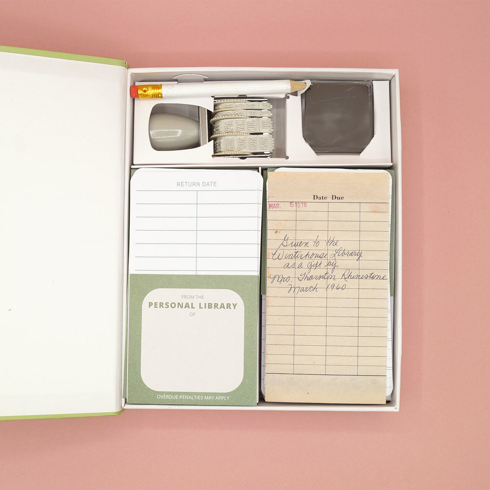 An open box shows items for a Personal Library Kit including a date stamp, pencil, ink pad, and pieces of paper to write due dates
