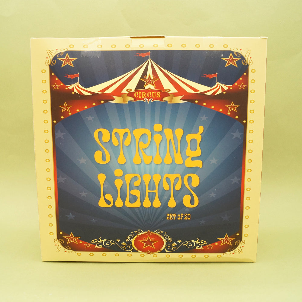 Box of string lights with circus-themed design on a yellow background