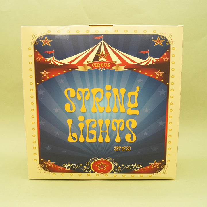 Box of string lights with circus-themed design on a yellow background