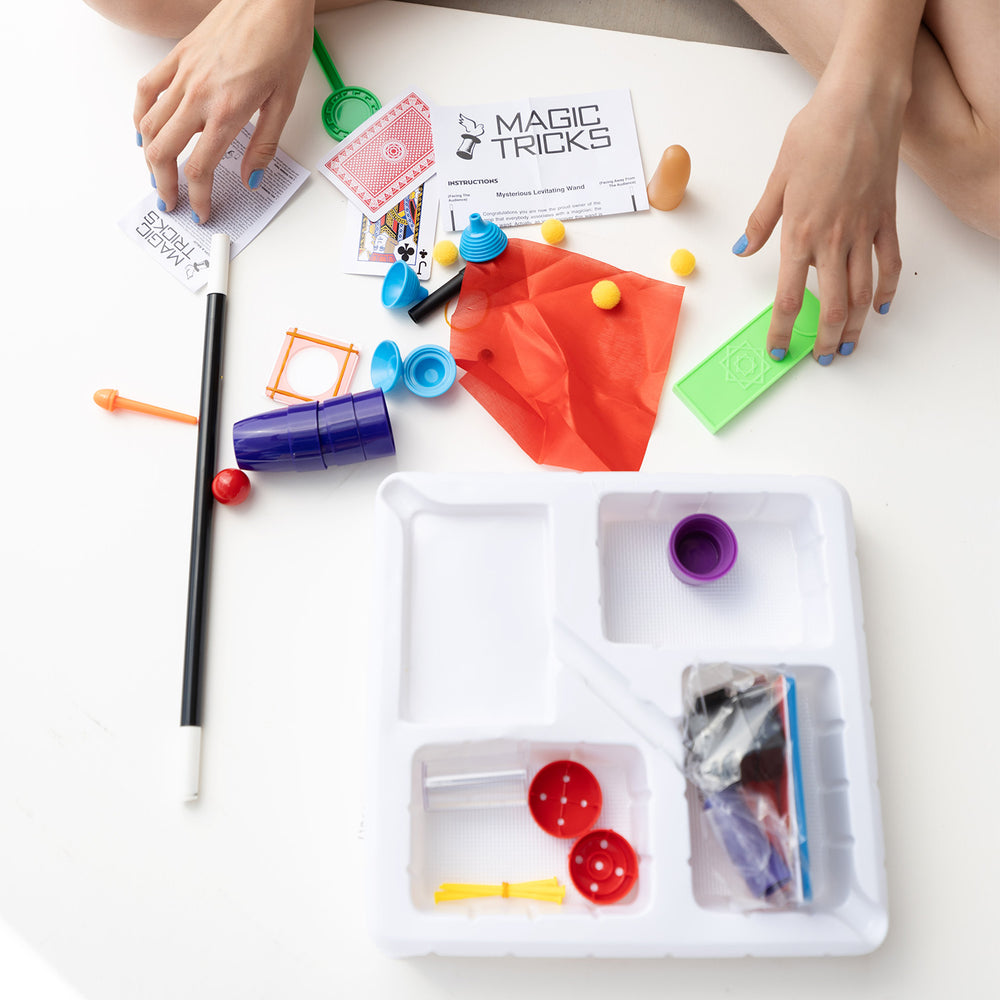 An array of magic trick pieces spread out on the floor.
