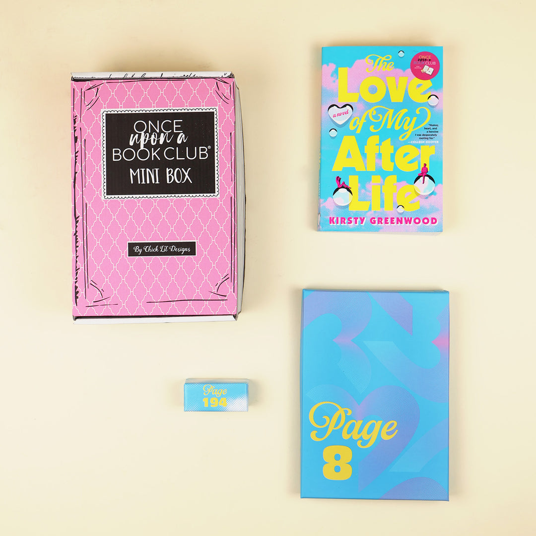 A flat-lay arrangement of a book club mini box, a book titled 'The Love Song After Life' by Kirsty Greenwood, a blue gift box labeled with PAGE 8, and a small blue and white gift with PAGE 198 on a cream background.