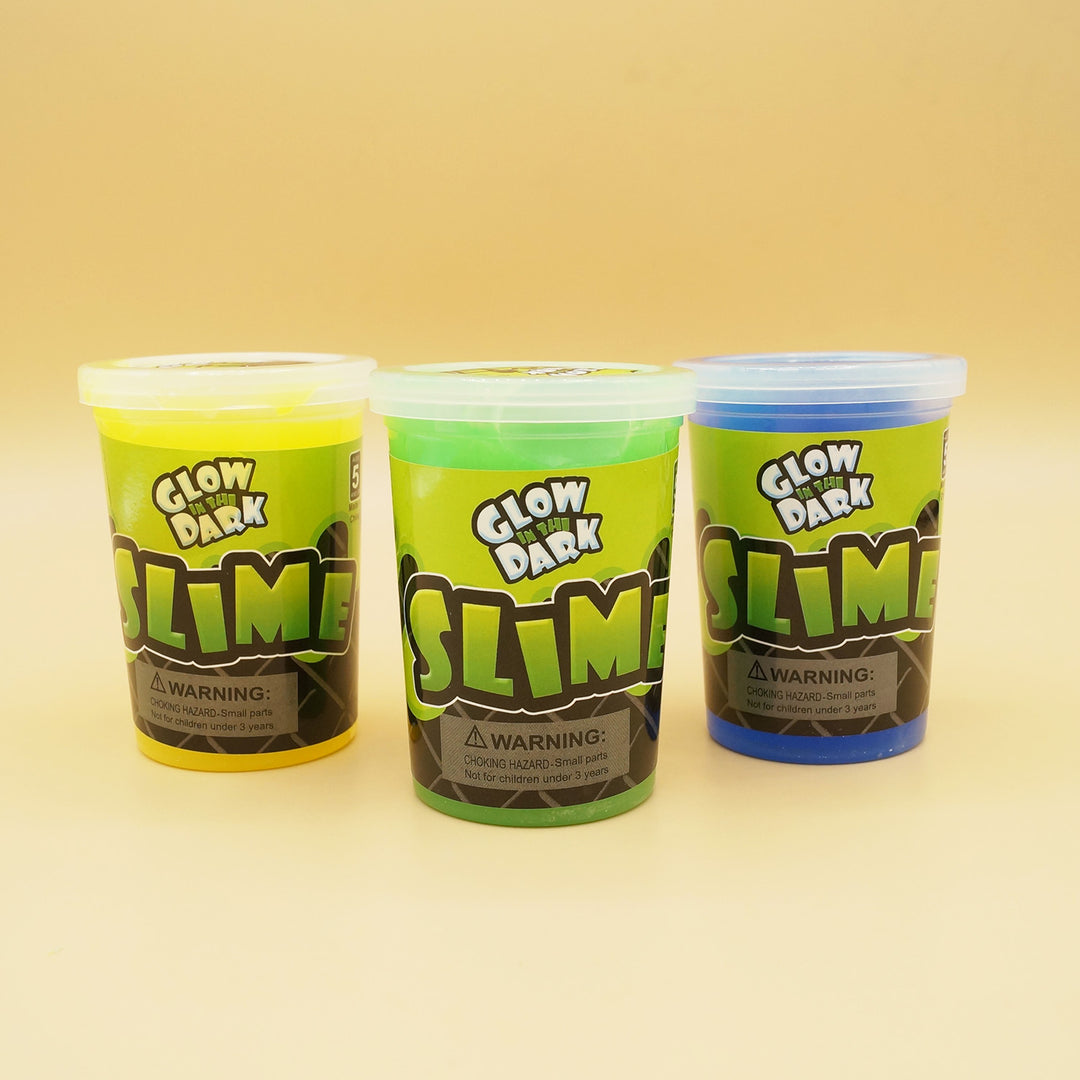 three containers of Glow in the Dark Slime in a line. From left to right they are yellow, green, and blue