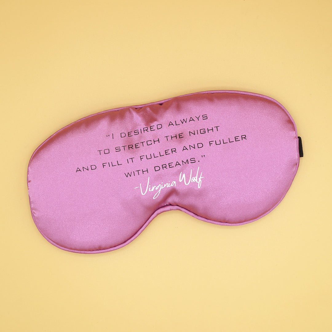 a pink sleep mask with the quote "I desired always to stretch the night and fill it fuller and fuller with dreams" - Virginia Woolf