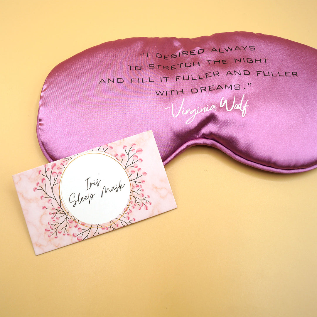 a pink sleep mask with the quote "I desired always to stretch the night and fill it fuller and fuller with dreams" - Virginia Woolf