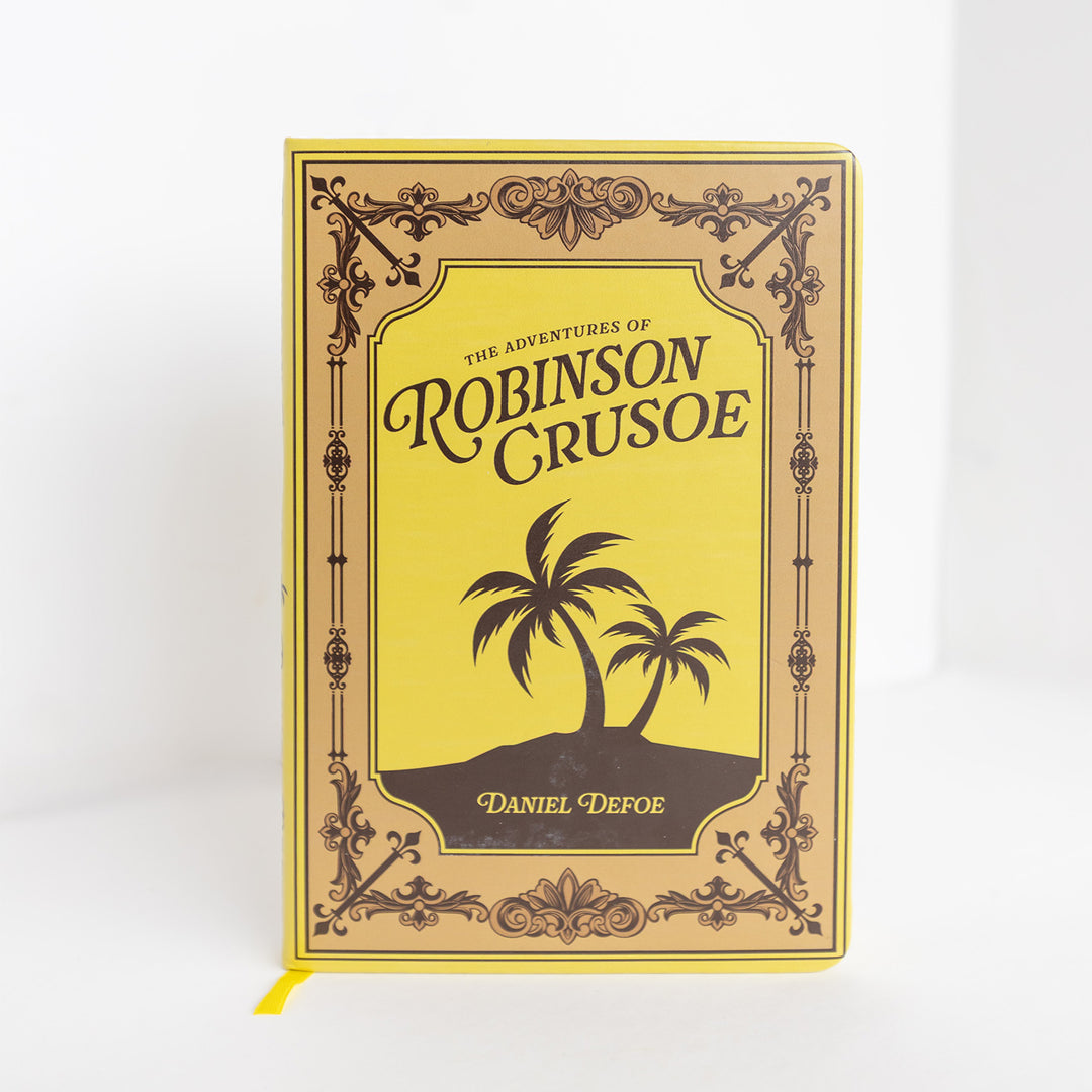A yellow journal made to look like the front cover of The Adventures of Robinson Crusoe by Daniel Defoe. The cover shows a silhouette of palm trees on an island.