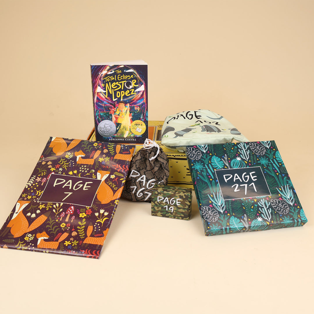 A paperback edition of The Total Eclipse of Nestor Lopez stands on a yellow OUABC box next to a wrapped gift labeled with a page number. In front of the box are four more themed wrapped gifts labeled with page numbers.
