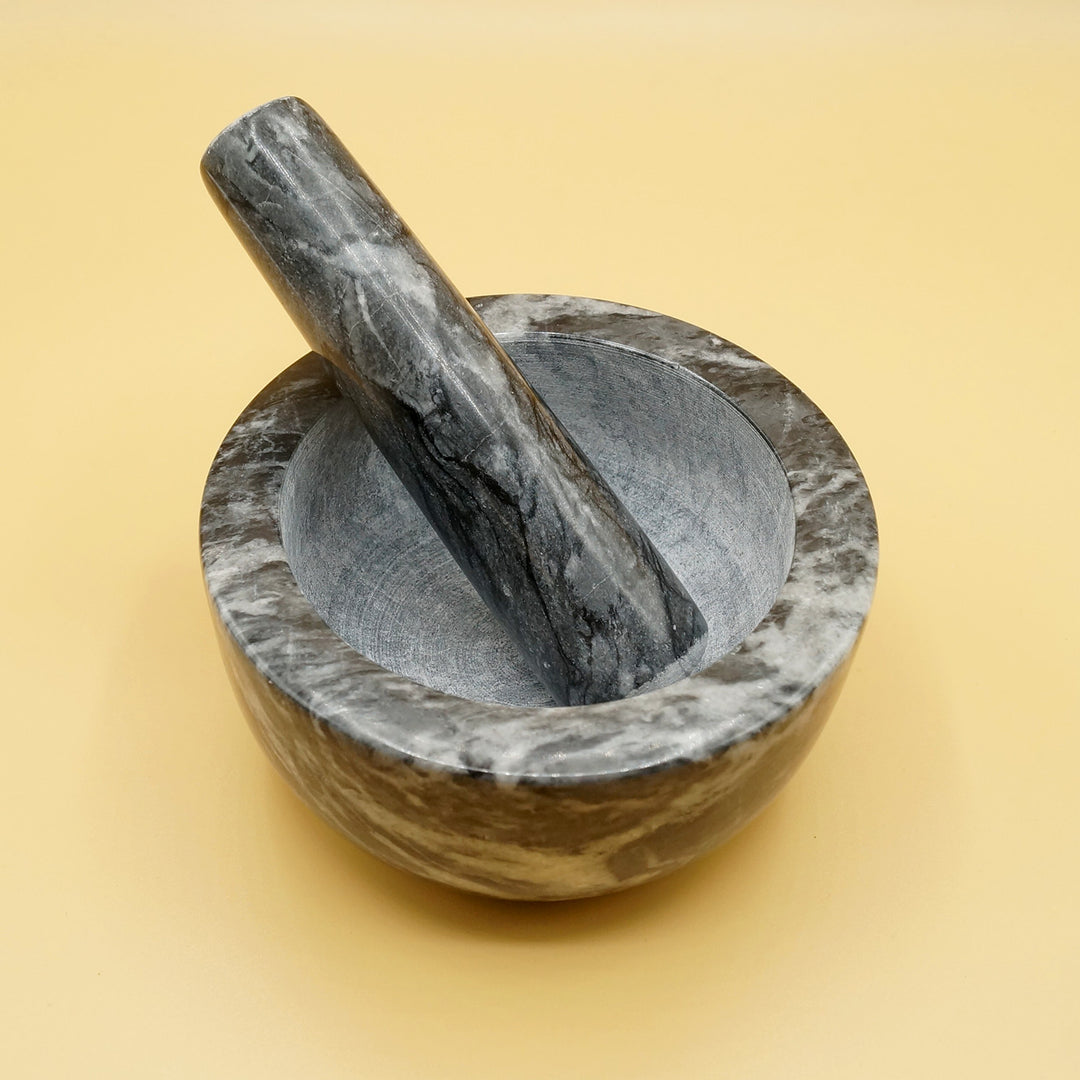 a black marble mortar and pestle 