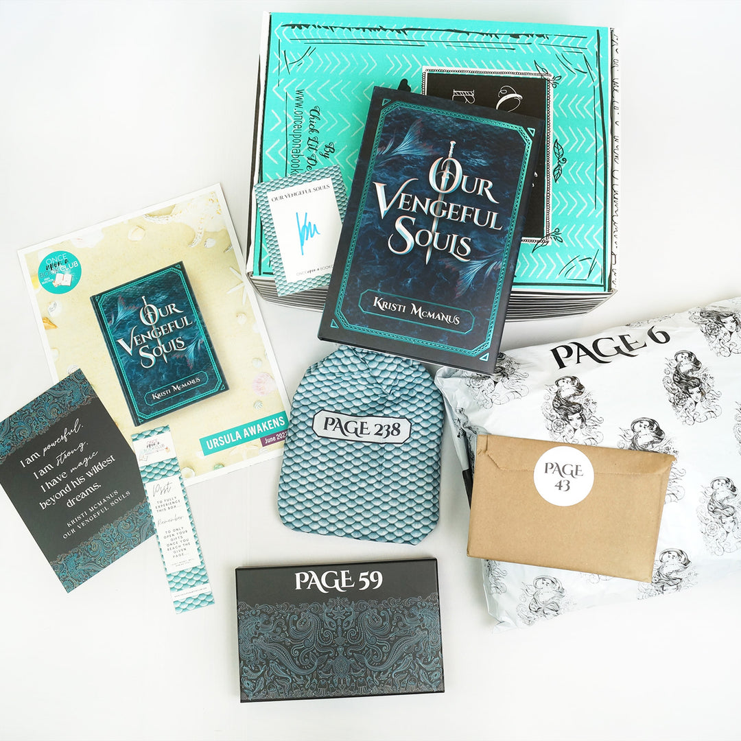 a hardcover special edition of Our Vengeful Souls lays on a green box next to a signature card. In front of the green box (from left to right) are a quote card, bookclub kit, bookmark, teal drawstring bag, rectangular box, brown paper envelope, and white polybag. The boxes and bags all have page numbers.