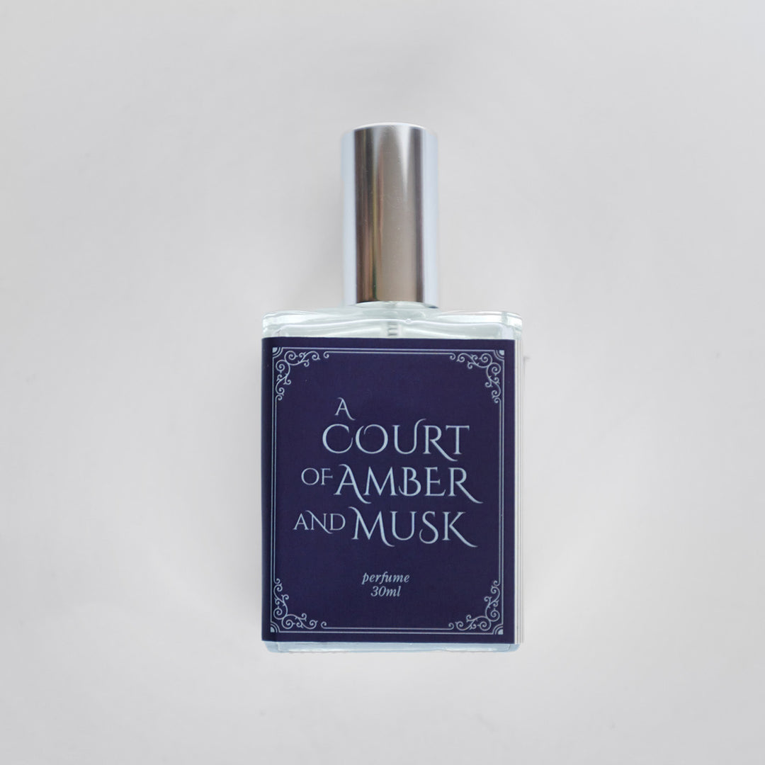 A closeup of the bottle containing the fragrance "A Court of Amber and Musk".