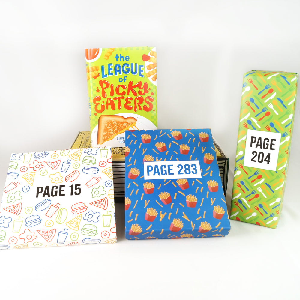 A yellow box on a white background. On top of the box stands a hardcover edition of "The League of Picky Eaters". Surrounding the book and box are 3 wrapped boxes labeled with page numbers to open as you read the book.