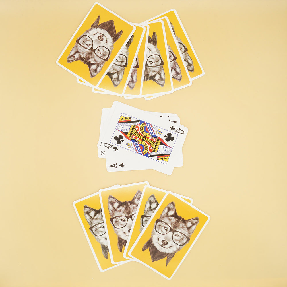 shows multiple piles of playing cards with an image of a wolf wearing glasses on the back of each of them