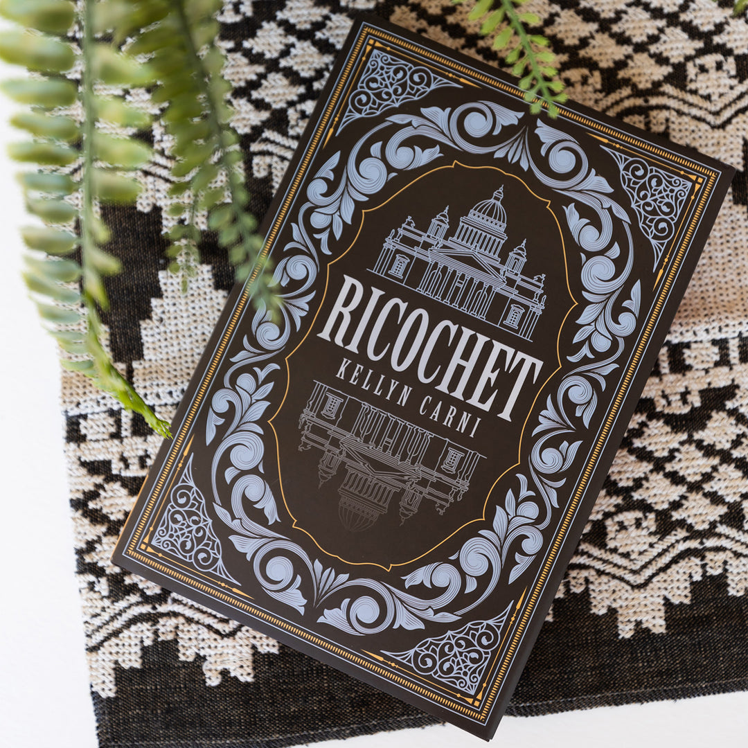 An exclusive edition of 'Ricochet' by Kellyn Carni on a textured surface with plants.