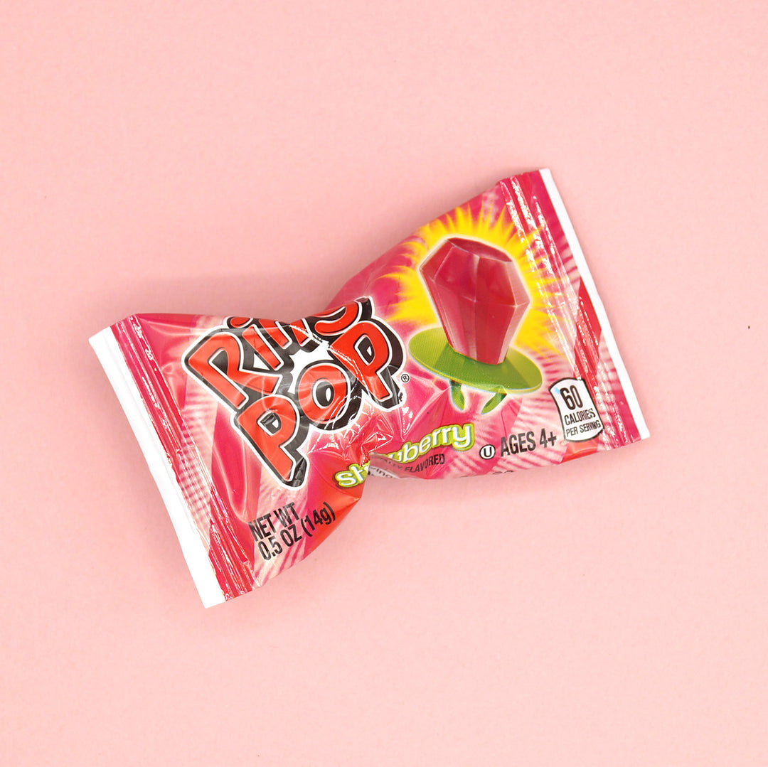 A strawberry flavored ring pop in its packaging.