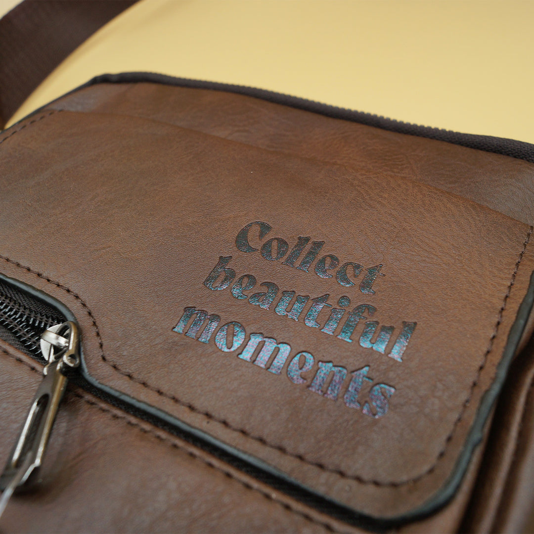 a brown satchel with the quote "Collect Beautiful Moments" printed on the front