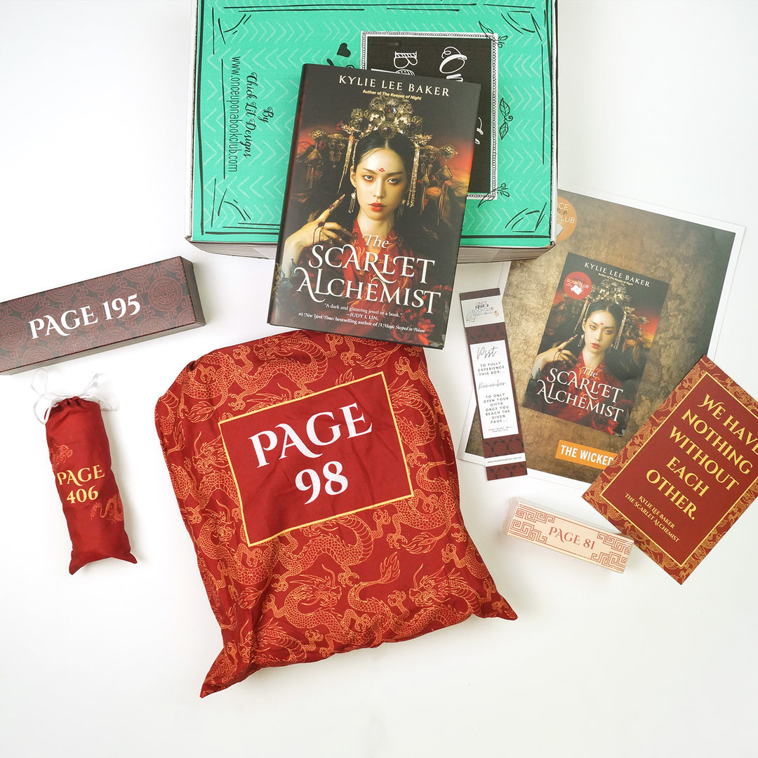 a hardcover copy of The Scarlet Alchemist sits on a green box. In front of the box, from left to right, are a rectangular black and red box, a small red drawstring bag, a large red drawstring bag, bookmark, bookclub kit, quote card, and small white and red rectangular box. The boxes and bags all have page numbers.
