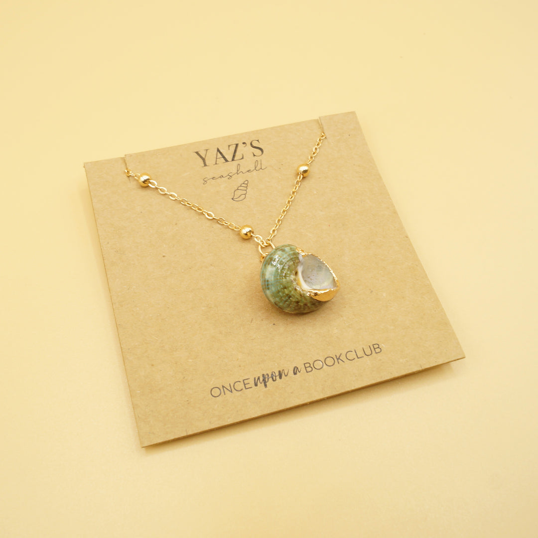 a green and gold seashell necklace with a gold chain