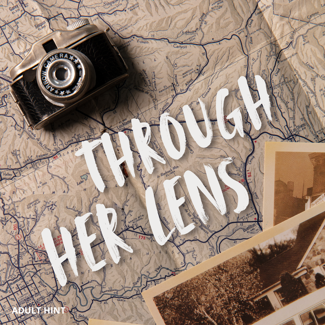September Adult hint image: A vintage camera and photos on a map with 'Through Her Lens' text.