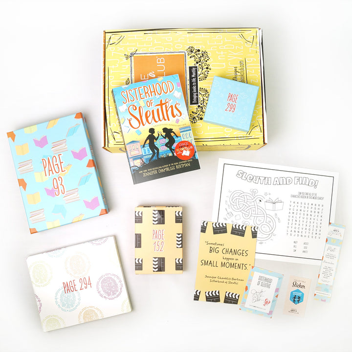 A paperback copy of Sisterhood of Sleuths by Jennifer Chambliss Bertman surrounded by wrapped gifts labeled with page numbers and paper items.