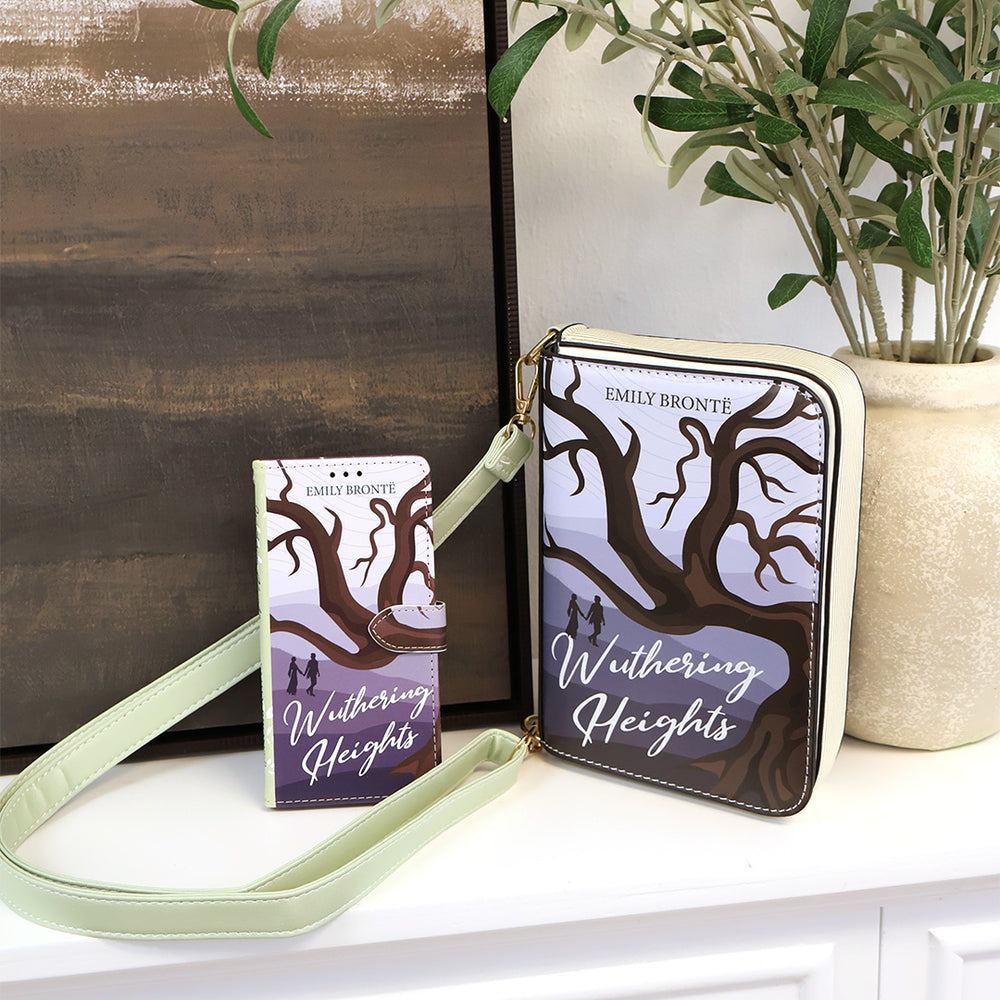 Wuthering Heights book and matching purse on a surface with a plant in the background