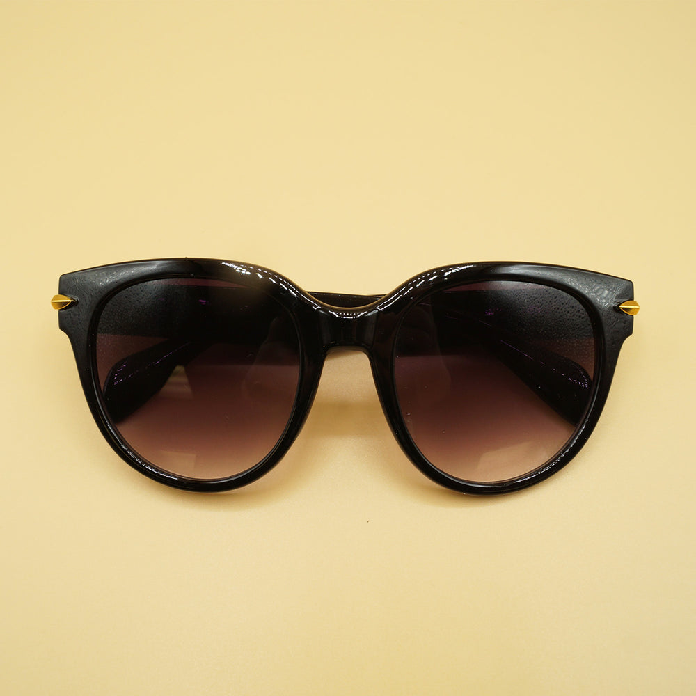 black sunglasses sit on a yellow background