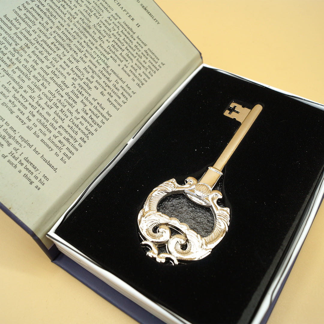 a golden key lays in a book-shaped box