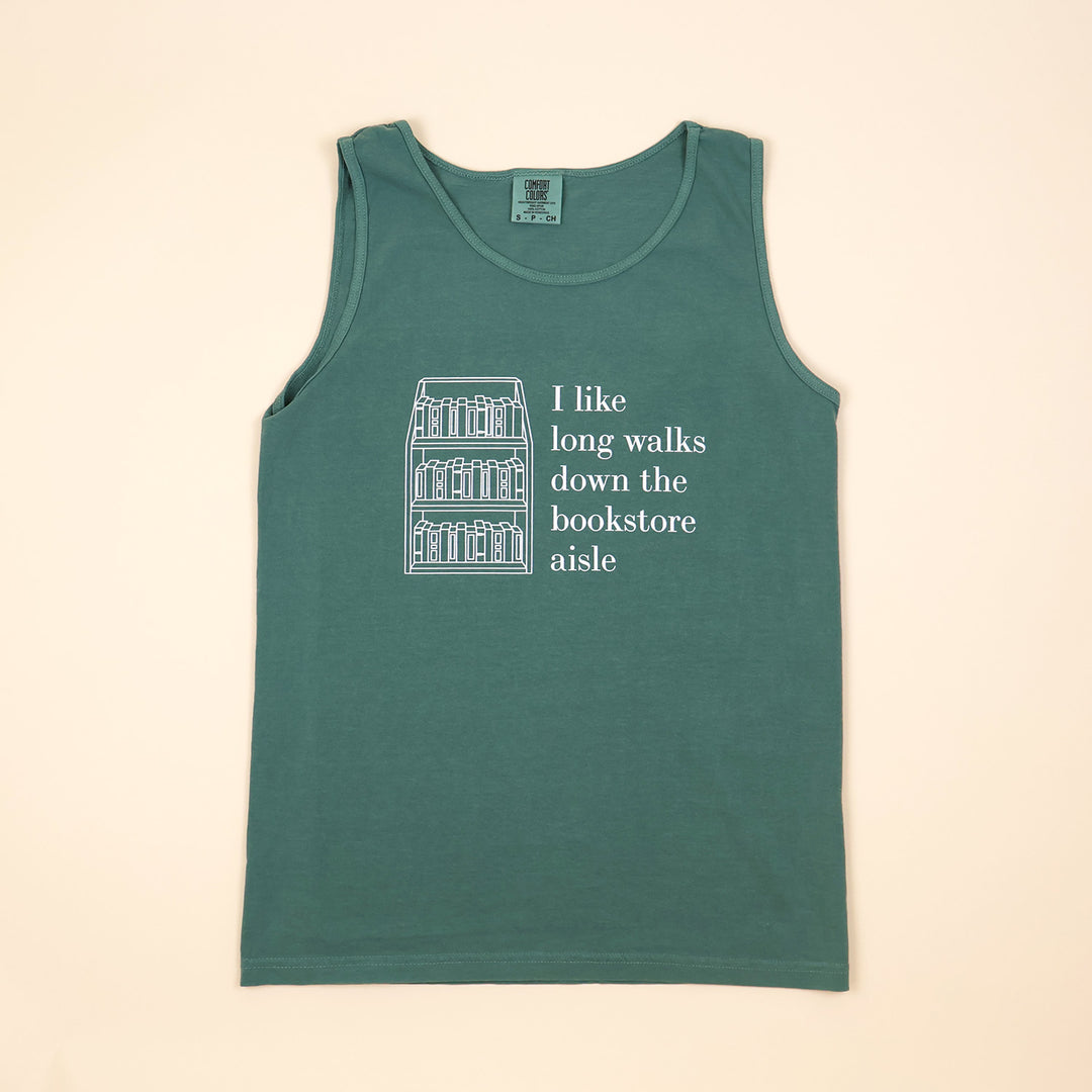 A green tank top with text that reads 'I like long walks down the bookstore aisle' and bookshelf graphic on a beige background.
