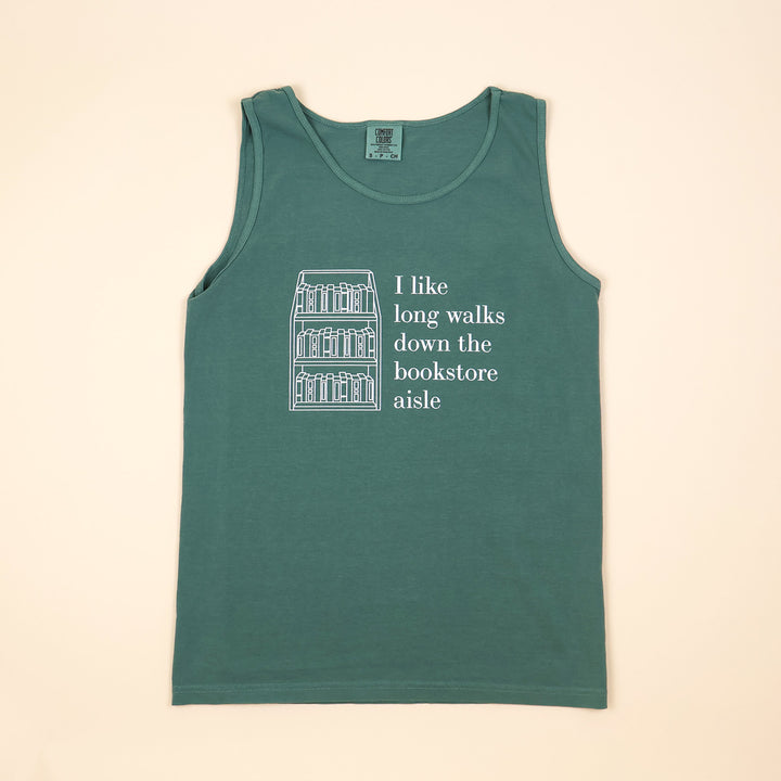 A green tank top with text that reads 'I like long walks down the bookstore aisle' and bookshelf graphic on a beige background.