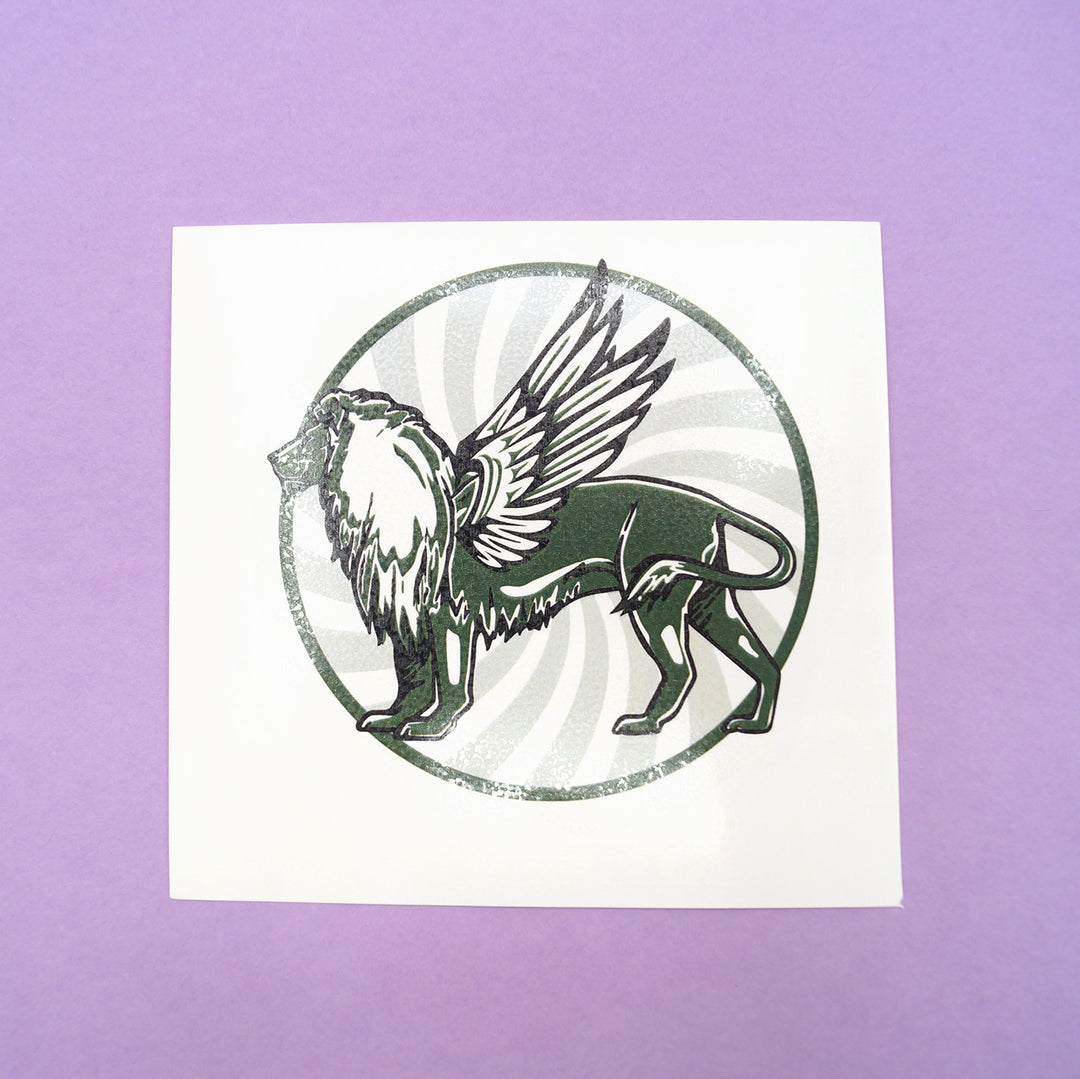 A circular tattoo with a winged lion on it