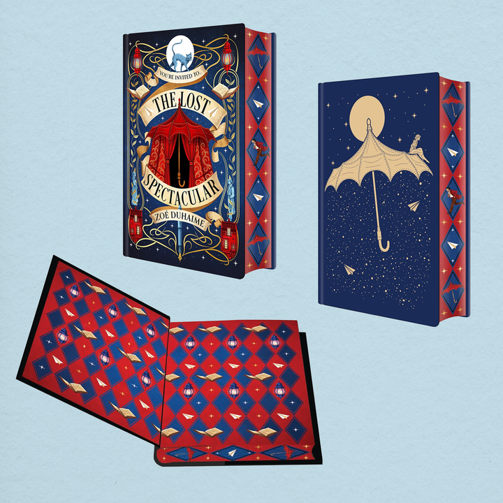 A decorative illustrated book shown from multiple angles on a pale blue background. The cover reads "The Lost Spectacular" and features a dark blue circus-style design with red and gold details, a red-and-blue patterned page edge design, and an open interior spread with matching red-and-blue patterned pages.