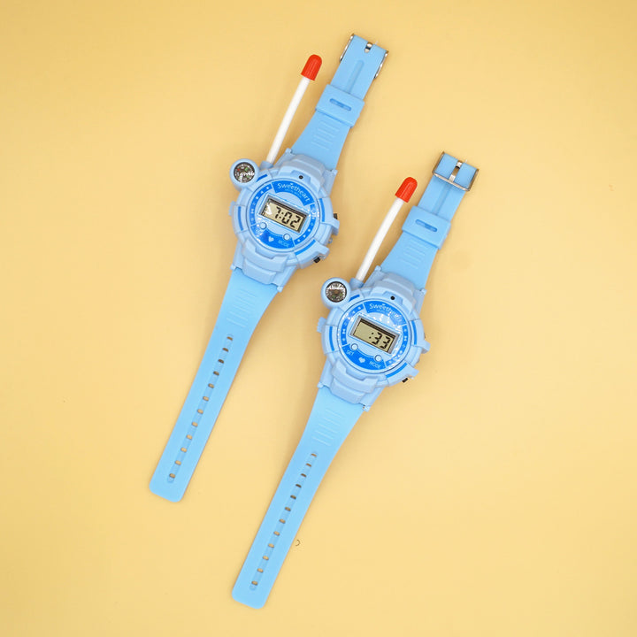 A set of two walkie talkie watches sits on a yellow background.
