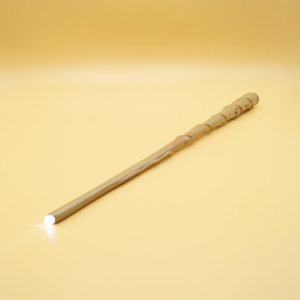 A yellow background. A magic wand points toward the viewer with a glowing tip.