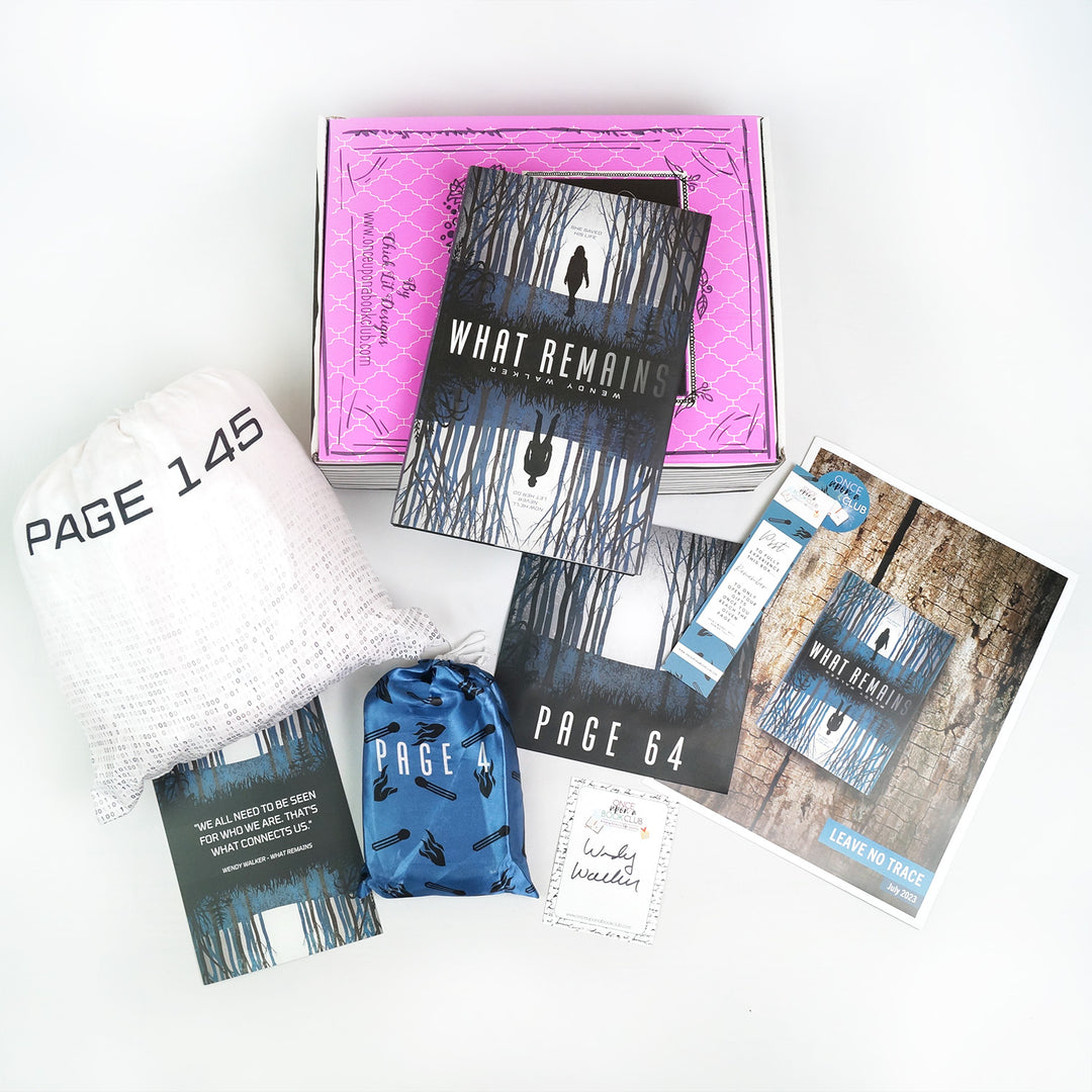A hardcover special edition of What Remains is on a pink box. In front are a large drawstring white bag, quote card, small blue drawstring bag, signature card, square box, bookmark, and bookclub kit. The boxes and bags all have page numbers.