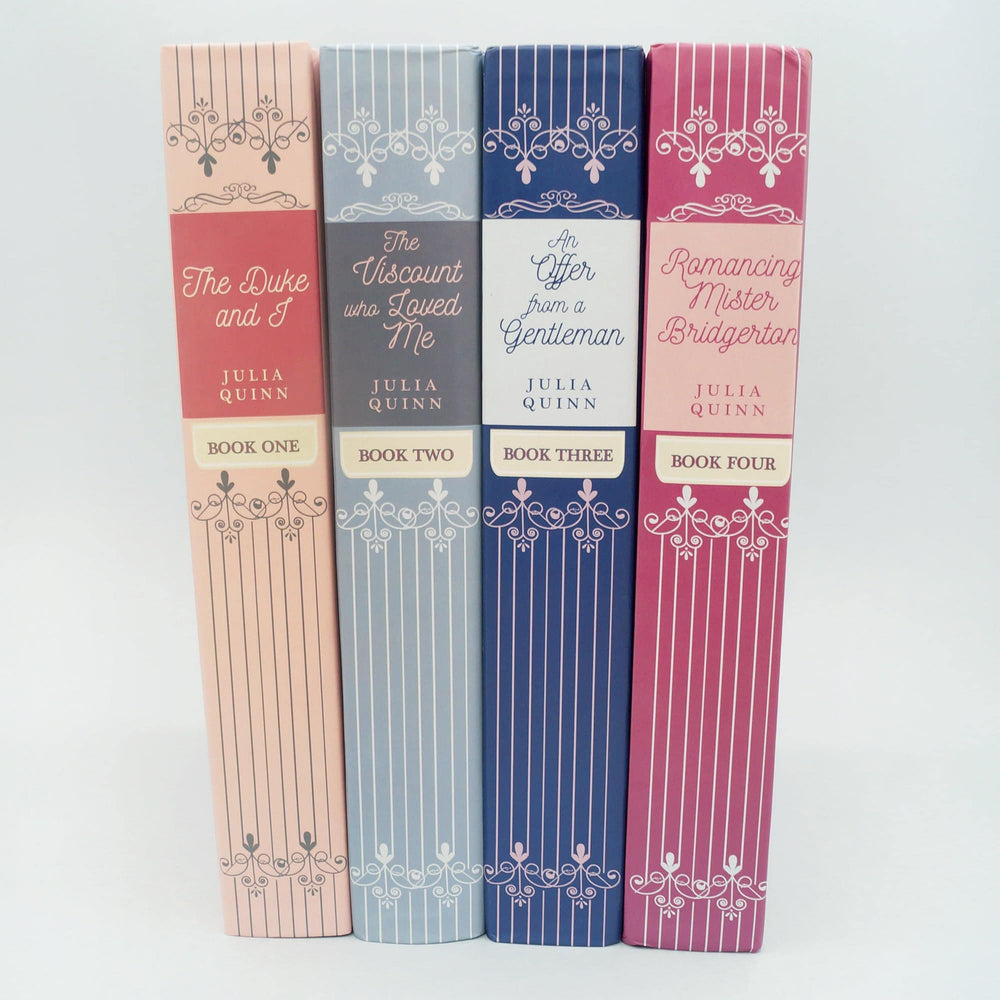 Hardcover special editions of Bridgerton Books 1-4 stand in a line showing the spines (The Duke and I, The Viscount Who Loved Me, An Offer from a Gentleman, and Romancing Mister Bridgerton)