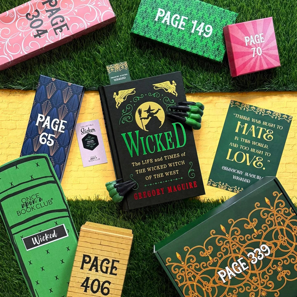 Book with 'Wicked' on a grassy surface surrounded by colorful bookends and bookmarks. Photo by bookapotamus on Instagram.