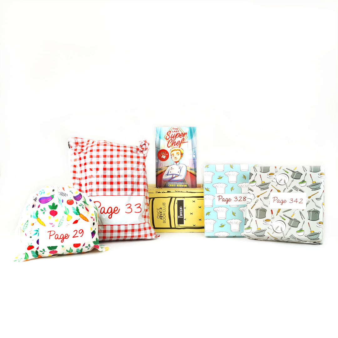 A copy of "The Last Super Chef" by Chris Negron on a yellow OUABC box surrounded by wrapped gifts