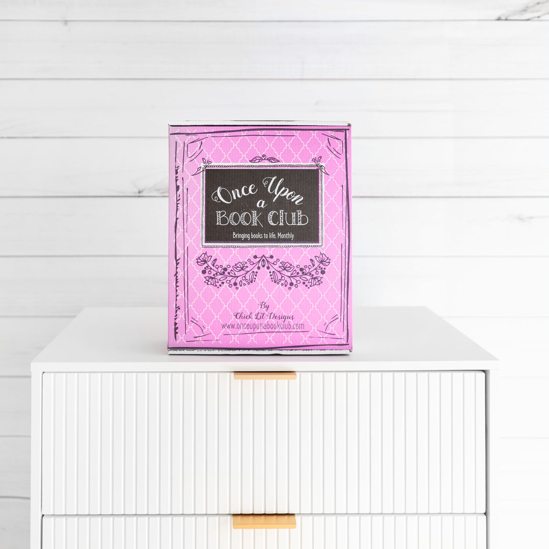 1 pink Once Upon a Book Club Adult box sits on a chest of drawers