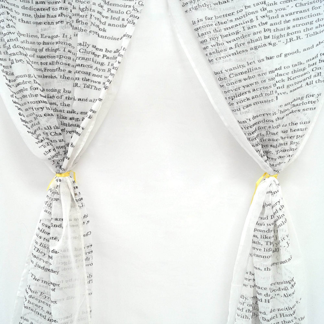 white curtains with book quotes in black writing across them
