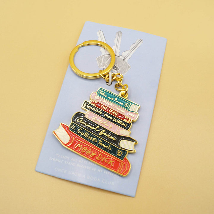 a bookstack keychain with gold ring