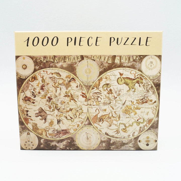 a box labeled 1000 Piece Puzzle and a constellation-themed map of the world on it