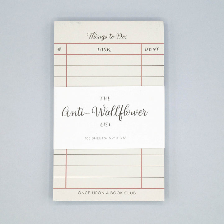 a white notepad labeled Things to Do with a white label across the center that says The Anti-Wallflower List