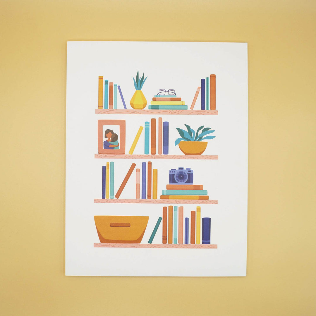 the front cover of a reading journal with a cartoon image of book shelves filled with books, plants, a camera, basket, and photo frame